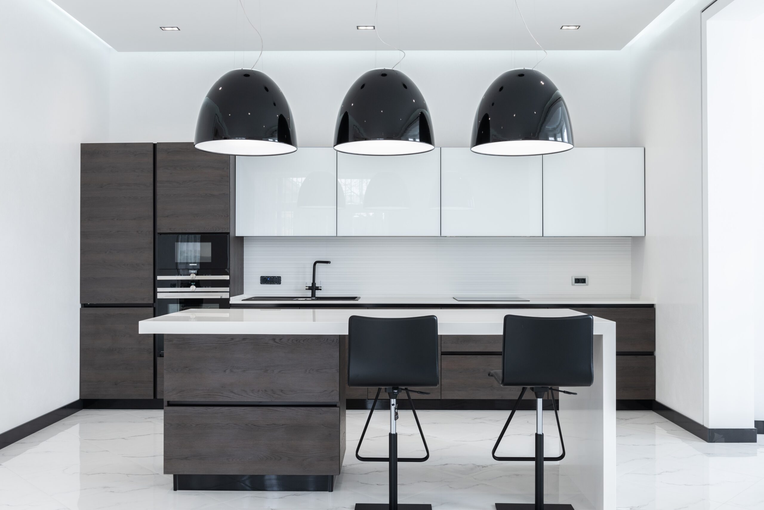 Modern kitchen with a large island and black pendant lights