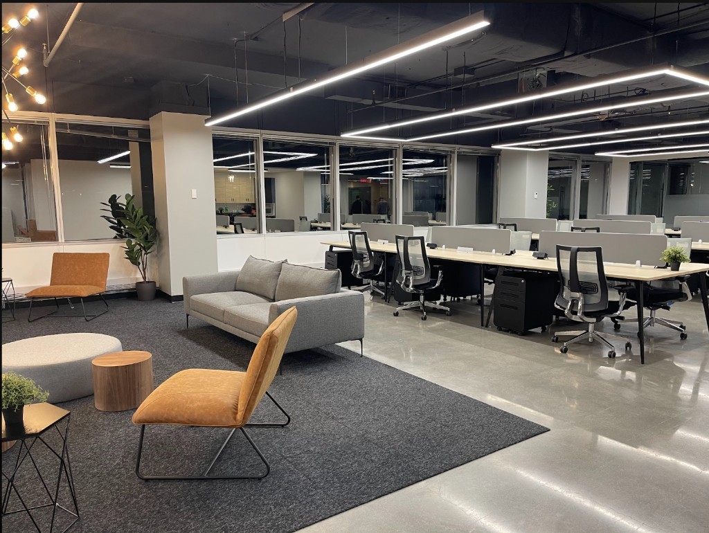 Open-concept office fit-up by Kastone Construction with lounge seating and workstations